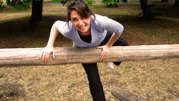 Fiona climbing over a wooden fence